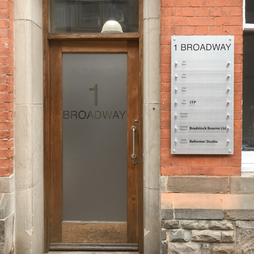 A full length glass door covered with frosted film.