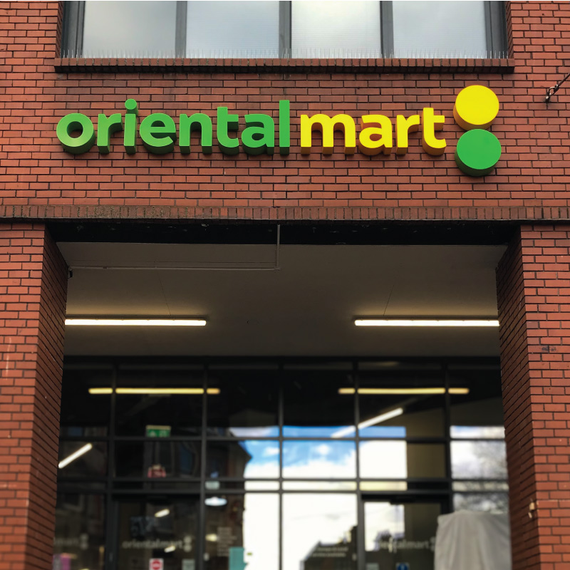 The exterior of a shop with 'Oriental mart' above in yellow and green acrylic 3D lettering