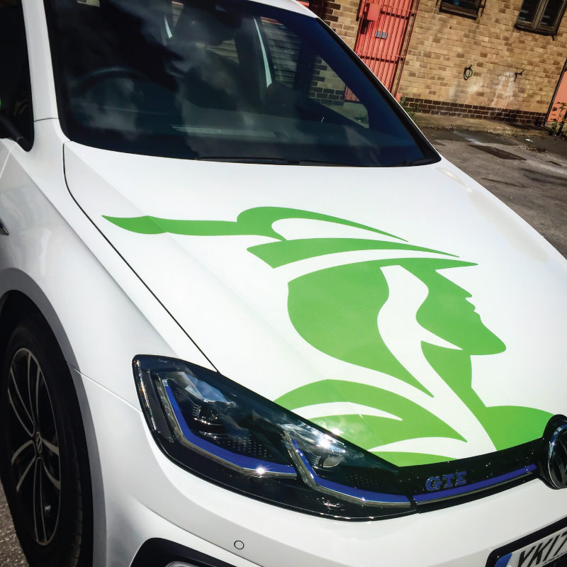 The image shows the bonnet of a white car. It has a large green graphic of the Nottingham logo over about half of the bonnet.