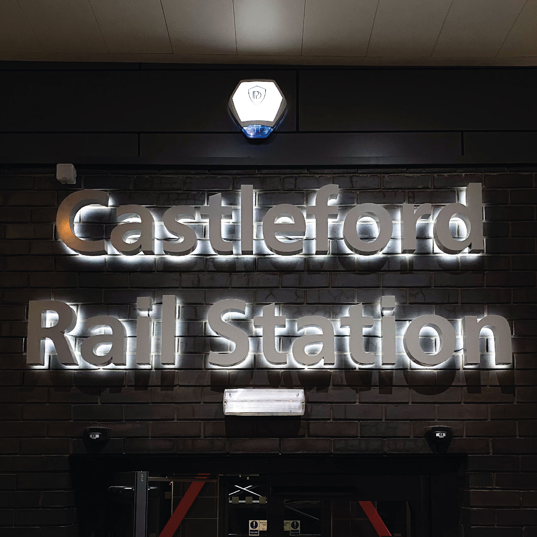 Castleford Rail Station in silver letters with backlighting.