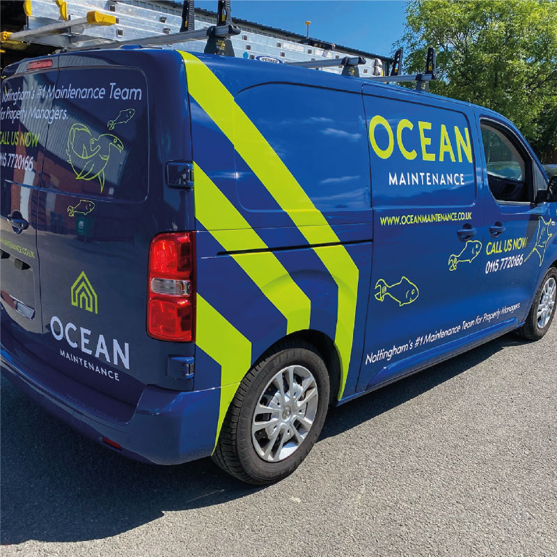 A small van that has been wrapped blue with neon green graphics. The graphics are the company logo, service and contact info and sea creatures drawn as maintenance tools e.g. hammerhead shark with a hammer for a head.