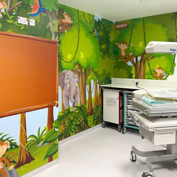 A pediatric resus room with a jungle theme wall wrap.