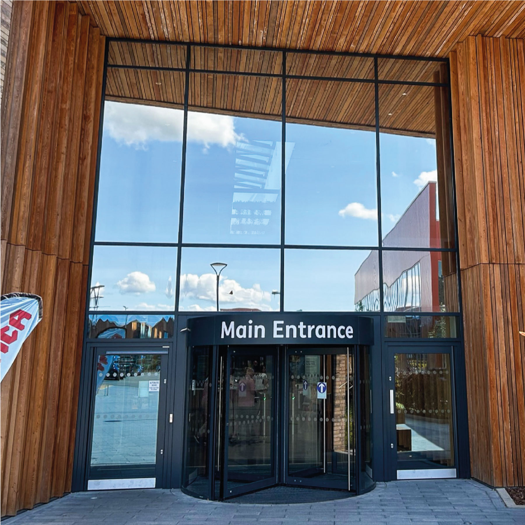 YMCA Main Entrance with a reflective film on the large windows above the door.